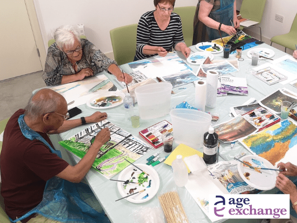 adults painting around a table