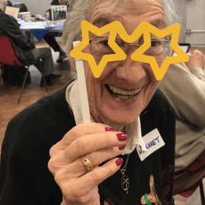 Age UK Enfield CEO website post elderly person with starry glasses