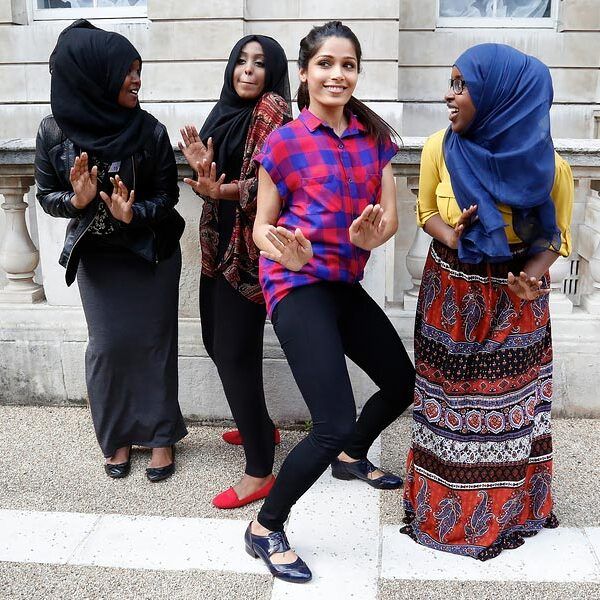 charity volunteers dancing in a line outside
