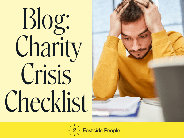 Words Blog Charity Crisis Checklist and a man in a yellow jumper with his hands on his head looking at a paper.