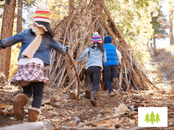 Wander Wild Forest School Case Study Website Post children runing into a wigwan built out of sticks