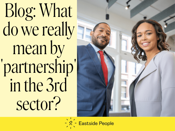 A banner slide with the words Blog: What do we really mean by 'partnership' in the 3rd sector? and a photo of a black man and woman. Blog by Dolyanna Mordochai