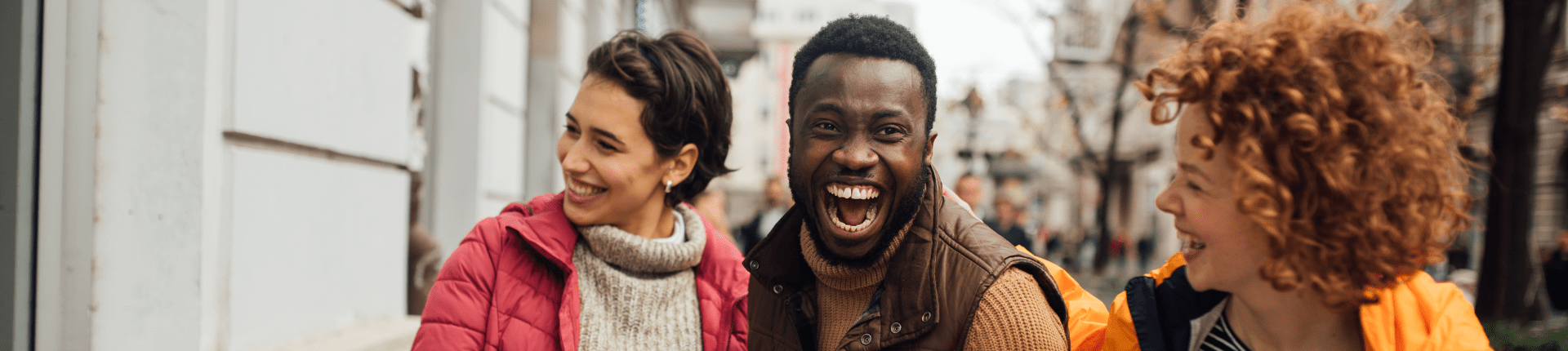 Asian woman and black man looking happy. BRD Action Not Words Blog Banner (1920 x 430 px)