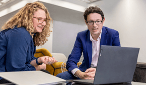 Bernice Rook (COO) and Richard Litchfield (CEO) of Eastside People looking at a laptop