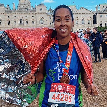 Fatima person in a silver blanket with a medal