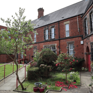 Harrison & Potter Trust trustees website post corner house with garden & standard red rose