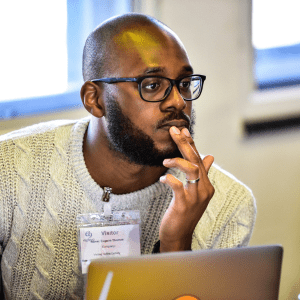 Patient Information Forum TreasurerFinance Trustee website post Black man looking thoughtfully at a screen