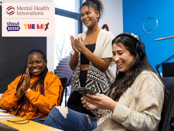 The Mix and MHI merger case study website post 1. 3 black/Asian young women engaging with online training via a screen and a mobile phone