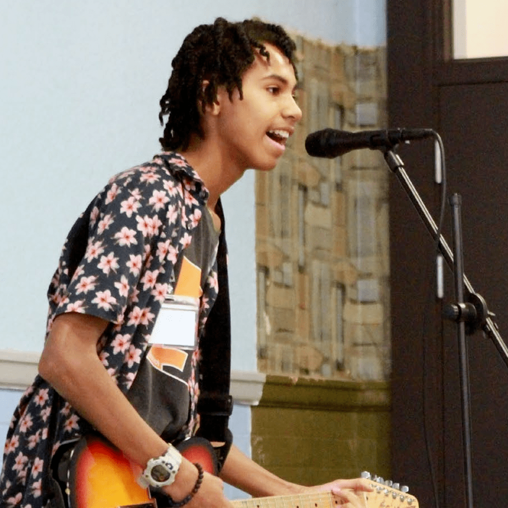 Alford House young man playing guitar and young man playing piano