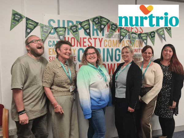 Nurtrio merger case study, faces of 3 people very close together, cheek to cheek with Nurtrio logo top right