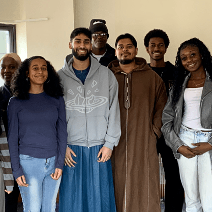 Diverse team at Aston-Mansfield of volunteers standing together smiling