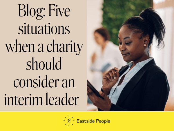 5 situations when a charity should consider an interim leader words and a photo of a youngish black lady smiling while looking at a tablet screen
