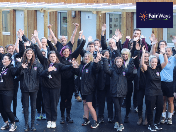 Fair Ways case study Website post group of people in navy blue Fair Ways tops waving their arms in the air
