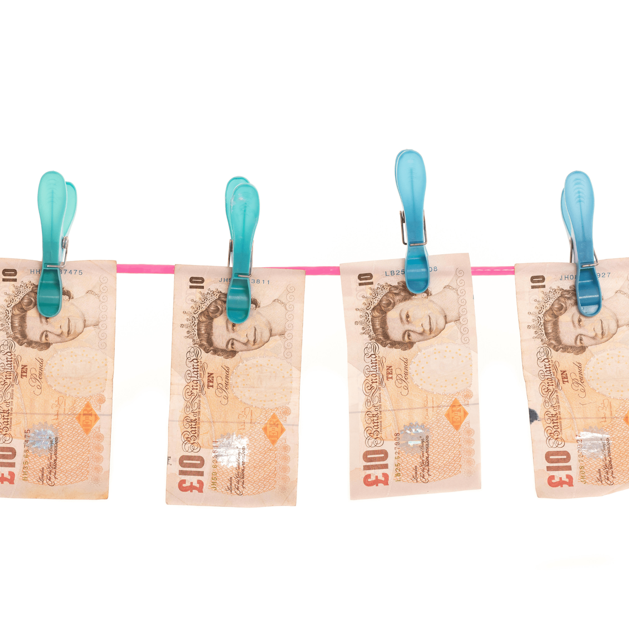 Spotlight on Corruption image of wet printed homemade UK ten pound bank notes hanging out to dry on a clothes line.