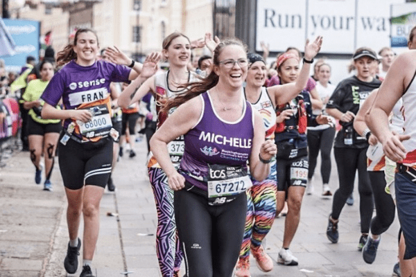 Buckinghamshire Healthcare charity London Marathon Michelle running in a purple vest top with her name across the front