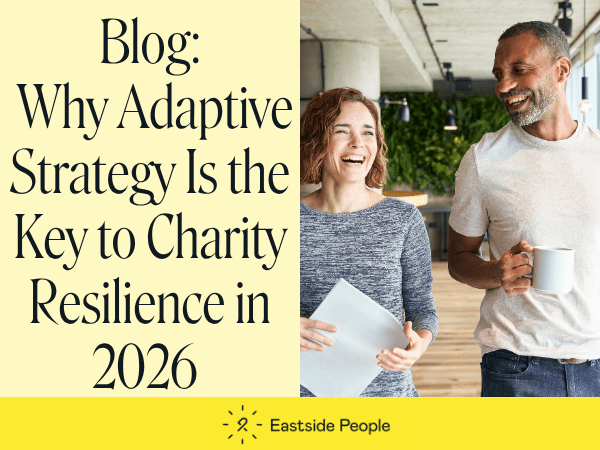 Words Blog Why Adaptive Strategy Is the Key to Charity Resilience in 2026 website post and a smiling woman and a man walking long a corridor. the main is holding a mug and th woman some paper.