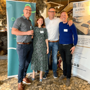 3 men and a woman smiling for a picture at a Charterpath event